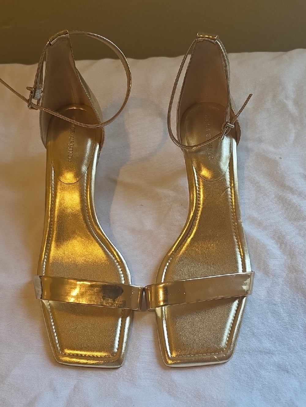 Vince Camuto gold ankle strap kitten heels.